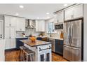 Modern kitchen with copper sink, stainless steel appliances, and custom island at 551 E Caley Dr, Centennial, CO 80121