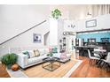 Bright living room featuring a modern design, high ceilings, and a beautiful open floor plan adjacent to the kitchen area at 7525 E 1St Pl # 1010, Denver, CO 80230