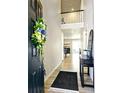 Welcoming entryway with wood floors, a decorative wreath, and view into the dining and living area at 7195 S Yantley Way, Aurora, CO 80016