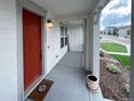 Inviting front porch with a red door and a view of the street at 3074 Distant Rock Ave, Castle Rock, CO 80109