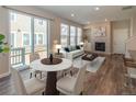 Bright living room features a fireplace, plush seating, and access to the outdoor balcony at 3074 Distant Rock Ave, Castle Rock, CO 80109