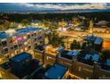 Stunning aerial night view of the neighborhood, showcasing the building's rooftop deck and city skyline at 2922 W 26Th Ave # 4, Denver, CO 80211