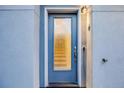 Elegant blue front door with glass pane, stylish hardware, and exterior light fixture at 2922 W 26Th Ave # 4, Denver, CO 80211