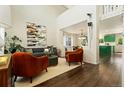 Bright living room featuring two-story ceilings, stylish seating, and an open floor plan at 11370 Iola St, Commerce City, CO 80640