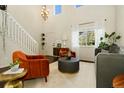 Bright living room featuring two-story ceilings, stylish seating, and an open floor plan at 11370 Iola St, Commerce City, CO 80640