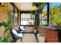 Inviting front porch with brick walls and comfy seating at 4425 King St, Denver, CO 80211