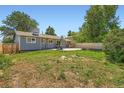 Large backyard featuring a patio area with a basketball hoop and plenty of room for activities at 2615 S Laredo Ct, Aurora, CO 80013