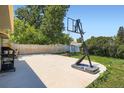 Concrete patio area with a basketball hoop, suitable for entertaining and outdoor enjoyment at 2615 S Laredo Ct, Aurora, CO 80013