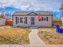 Inviting single-story home with a well-manicured lawn and a pathway leading to the front door at 1681 Nome St, Aurora, CO 80010