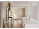 Modern kitchen with stainless steel refrigerator, white countertops, and a view of the entry at 4322 Quivas St, Denver, CO 80211