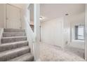 Hallway with carpeted stairs, white trim, and neutral walls at 11103 E Alameda Ave # 102, Aurora, CO 80012