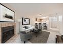Inviting living room with a fireplace, modern furniture, and access to the kitchen at 11103 E Alameda Ave # 102, Aurora, CO 80012