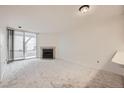 Living room featuring a cozy fireplace and sliding glass doors leading to the outside at 11103 E Alameda Ave # 102, Aurora, CO 80012