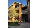 Multi-story condo building features brick accents, well maintained landscaping and private balconies with white railings at 1632 W Canal Cir # 924, Littleton, CO 80120