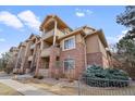 Attractive condo building with brick accents, multiple balconies, and landscaped surroundings at 1632 W Canal Cir # 924, Littleton, CO 80120