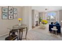 Bright living room featuring a fireplace, balcony access, and modern decor at 1632 W Canal Cir # 924, Littleton, CO 80120