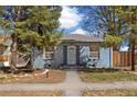 Charming single-story home with a blue exterior, mature trees, and a well-maintained front yard at 2570 Jay St, Edgewater, CO 80214