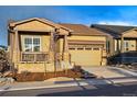 Inviting home boasts a covered porch, a well-kept lawn, and an attached two-car garage at 5506 Water Avens Dr, Castle Rock, CO 80104