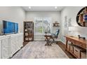 Bright home office space with a large window, wood floors, and comfortable furnishings at 5506 Water Avens Dr, Castle Rock, CO 80104