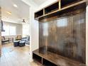 Entryway with built-in bench, coat hooks, and wood-paneled walls at 4525 Cholla Trl, Castle Rock, CO 80104