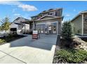 Two-story Craftsman home with gray siding, light-colored stone accents, and a three-car garage at 4525 Cholla Trl, Castle Rock, CO 80104