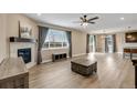Open living area with hardwood flooring, fireplace, large windows and sliding glass door access to a rear deck at 467 White Sand Trl, Castle Rock, CO 80104