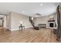 Spacious living room featuring hardwood floors, fireplace, and a staircase leading to the upper level at 467 White Sand Trl, Castle Rock, CO 80104