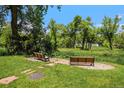 Two benches facing each other surrounded by green grass and trees at 8039 Lee Dr # 2, Arvada, CO 80005