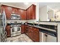 Well-equipped kitchen features stainless steel appliances, dark countertops, and ample cabinet space for storage and food preparation at 8039 Lee Dr # 2, Arvada, CO 80005