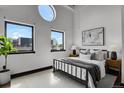 Bedroom featuring bright natural light from large windows, neutral colors, and simple decor at 2715 Blake St # 304, Denver, CO 80205