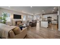 Open concept living area with kitchen, dining, and living spaces at 10092 Flower St, Broomfield, CO 80021