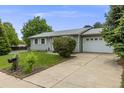 Well-maintained home with a green lawn, mature landscaping, and a paved driveway leading to a two-car garage at 3058 W 134Th Way, Broomfield, CO 80020