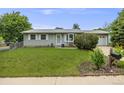 Attractive single-story home with a lush front yard, complemented by a cozy bay window and attached garage at 3058 W 134Th Way, Broomfield, CO 80020