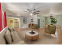 Bright living room with hardwood floors, a ceiling fan, and abundant natural light at 305 Titan St, Aurora, CO 80011