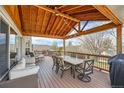Inviting covered deck with ample seating, dining space, and string lights for outdoor enjoyment at 2369 Bayberry Ln, Castle Rock, CO 80104