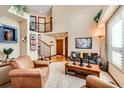 Bright living room boasts large windows, hardwood floors, and comfortable seating, creating a welcoming atmosphere at 2369 Bayberry Ln, Castle Rock, CO 80104