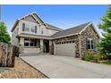 Attractive two-story home featuring stone accents and a convenient attached two-car garage at 8071 Tabor St, Arvada, CO 80005