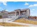Charming one-story home with a two-car garage, stone accents, and covered front porch at 1931 Marlowe W Cir, Erie, CO 80516