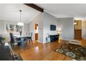 Open-concept living and dining area features hardwood floors, a vaulted ceiling and flows into the kitchen at 1768 E Jamison Ave, Centennial, CO 80122