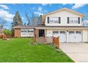 Inviting two-story home with a well-maintained lawn, attached two-car garage, and neutral-colored siding at 1768 E Jamison Ave, Centennial, CO 80122