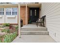 Inviting covered front porch with decorative bench and freshly painted front door at 1768 E Jamison Ave, Centennial, CO 80122