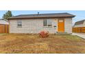 Home with a large boulder, freshly laid topsoil, new windows and inviting orange front door at 272 Balsam Ave, Brighton, CO 80601