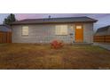 Charming home with a large boulder, freshly laid topsoil, new windows and inviting orange front door at 272 Balsam Ave, Brighton, CO 80601