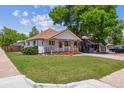 Charming single-story home with a well-maintained lawn and mature shade tree at 1101 Spruce St, Louisville, CO 80027