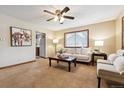 Cozy living room with carpeted floors, a ceiling fan, and natural light from the window at 1101 Spruce St, Louisville, CO 80027