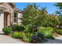View of lush garden featuring a variety of vibrant flowers and plants, enhancing the curb appeal of the home at 2276 S Norse St, Lakewood, CO 80228