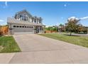 Inviting two-story home with a wide driveway and a well-maintained lawn, perfect for outdoor activities at 2006 E 97Th Ave, Thornton, CO 80229