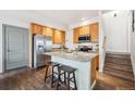 Kitchen featuring stainless steel appliances, granite countertops, a center island, and wooden cabinets at 9654 Martin Luther King Jr Blvd, Denver, CO 80238