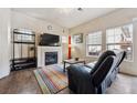 Cozy living room featuring a fireplace, TV, sleek furniture, and natural light streaming through the windows at 9654 Martin Luther King Jr Blvd, Denver, CO 80238