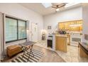 Sunlit kitchen area with a breakfast bar and modern appliances at 919 S Dawson Way # 17, Aurora, CO 80012